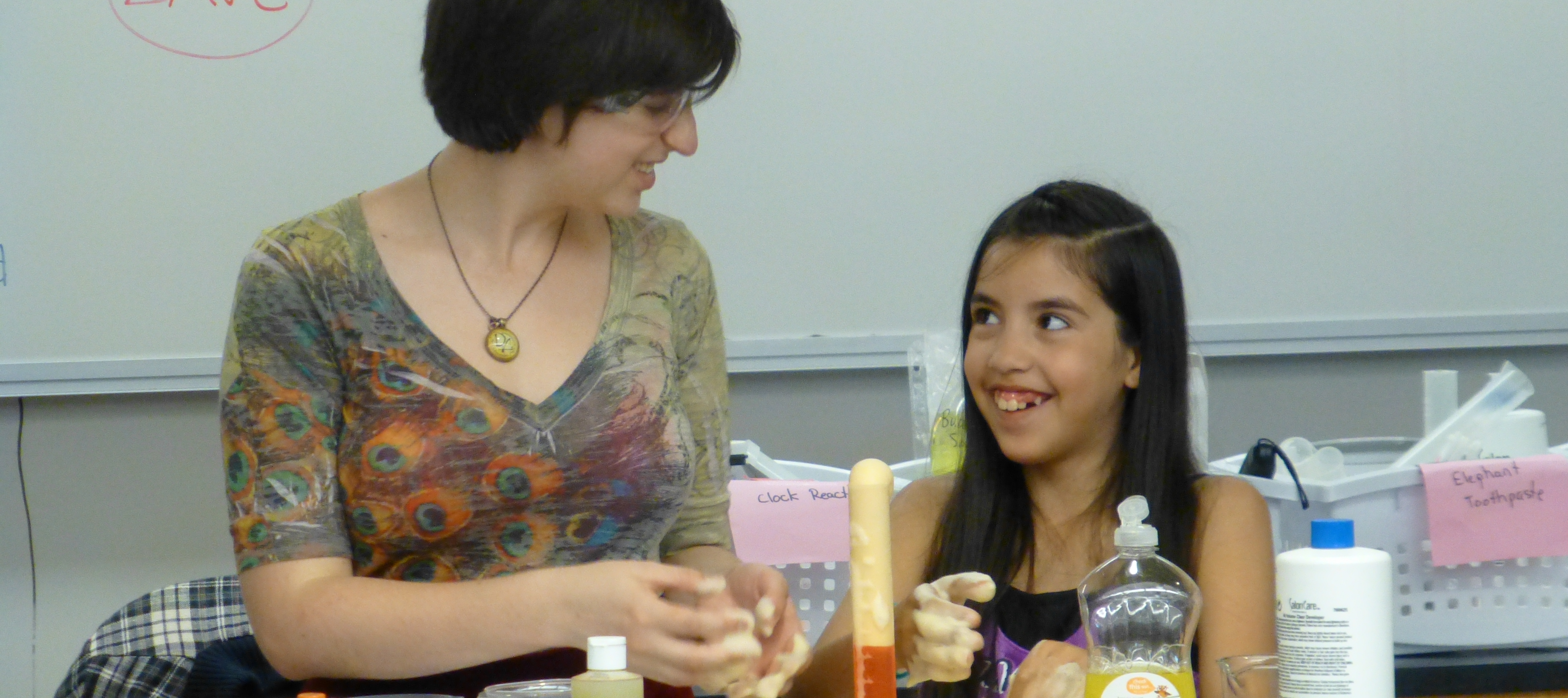 Reed student explores chemical reactions with an elementary student.